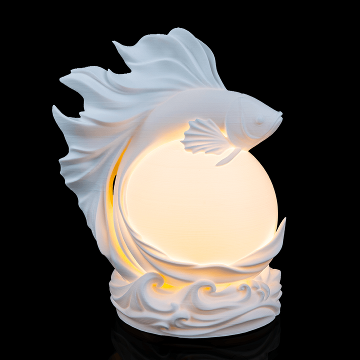 Betta Fish Sphere Desk Lamp glowing with flowing fish-inspired design wrapped around illuminated globe