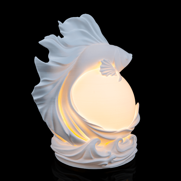 Betta Fish Sphere Desk Lamp on desk creating soft ambient lighting in modern workspace