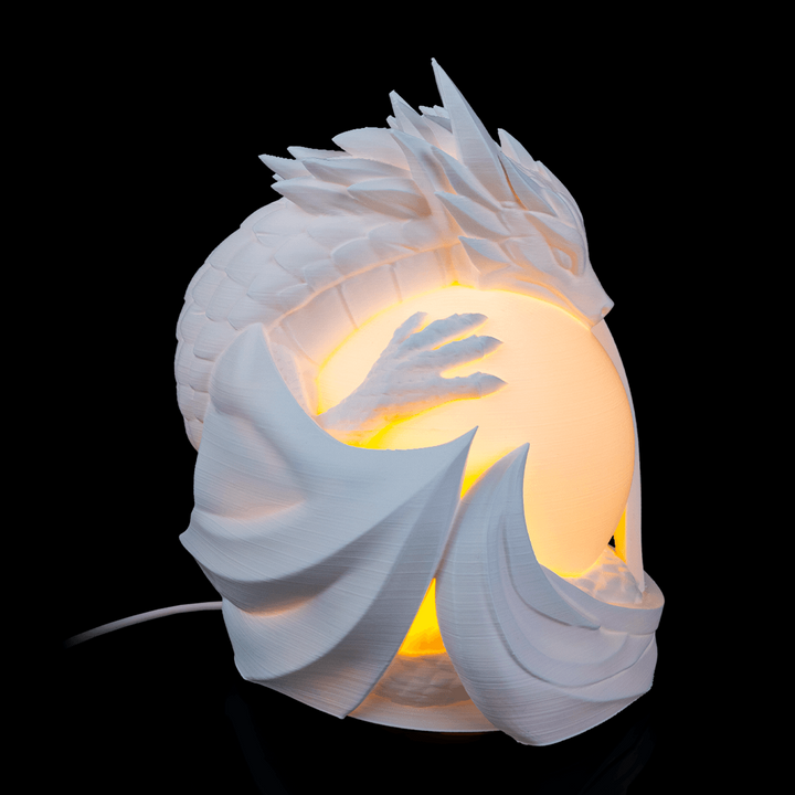 Dragon Sphere Desk Lamp placed on desk creating warm ambient lighting in fantasy-inspired room