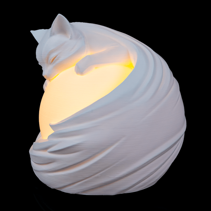 Feline Sphere Desk Lamp on nightstand creating warm ambient lighting in cozy room