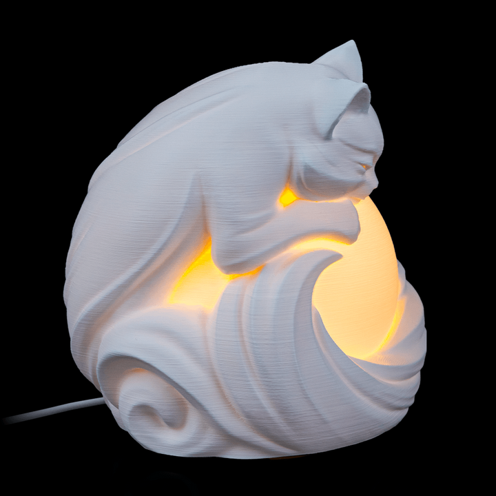 Close-up of Feline Sphere Desk Lamp highlighting cat features and layered sculptural details