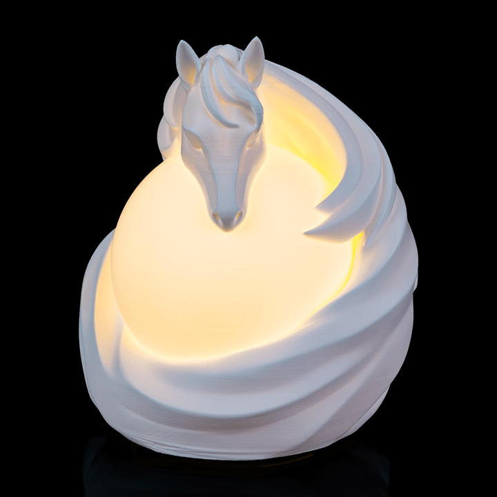 Stallion Sphere Desk Lamp glowing with sculpted horse design wrapped around illuminated globe