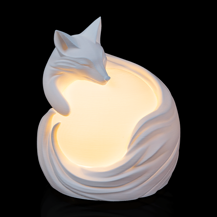 Vulpine Sphere Desk Lamp glowing with fox design wrapped around illuminated globe