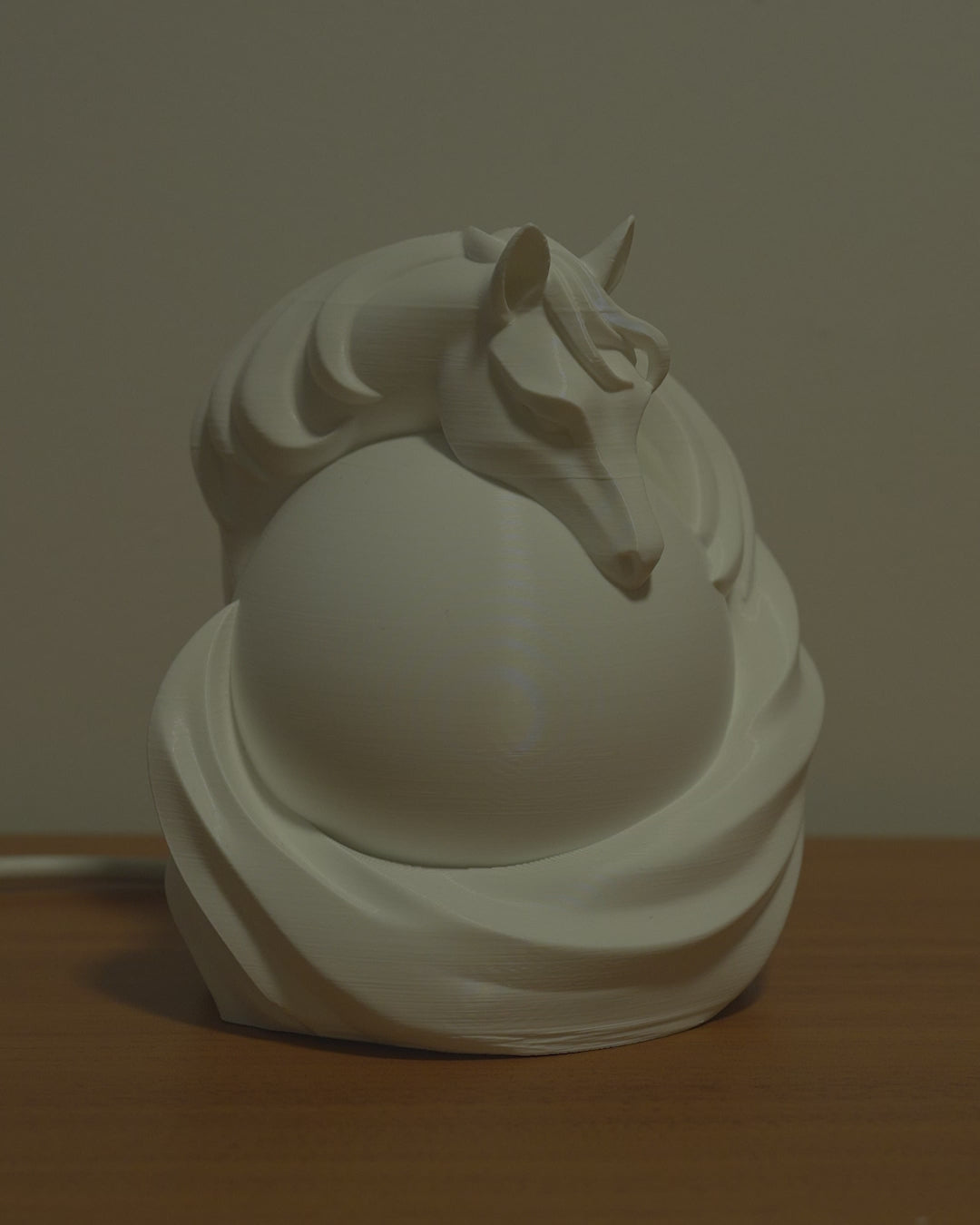 Stallion Sphere Desk Lamp video showing lamp turning on and casting warm glowing light through horse design