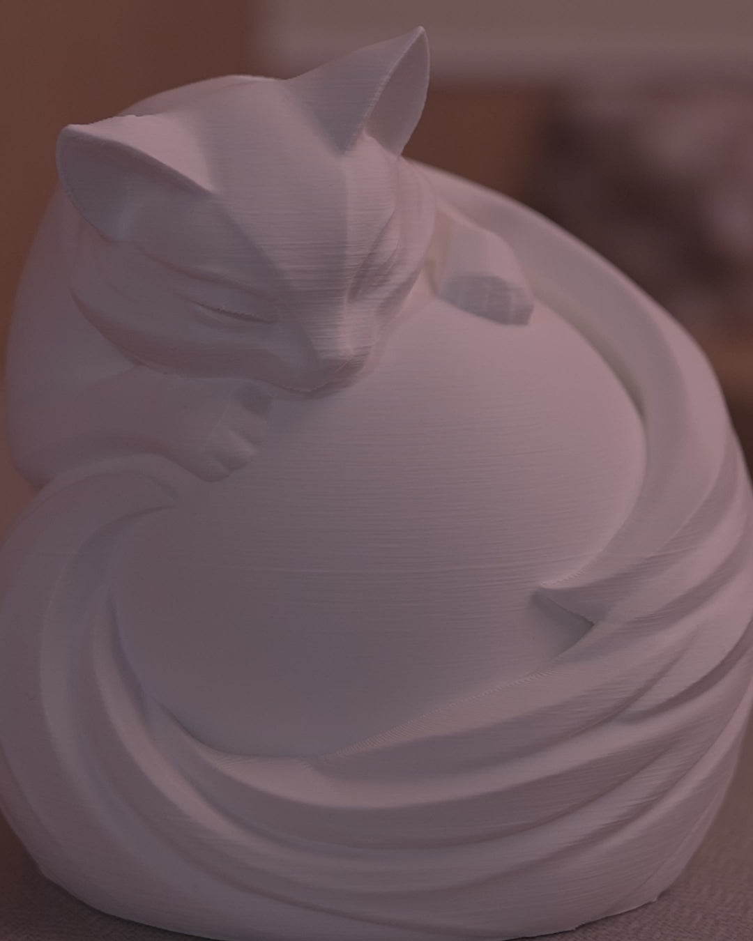 Video of Feline Sphere Desk Lamp glowing and rotating to showcase detailed cat design around illuminated globe